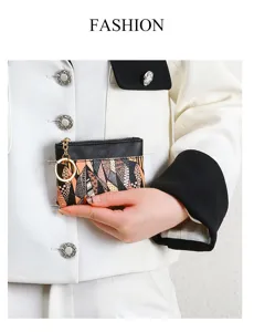 Detailed view of a compact geometric pattern coin purse with metal keychain and zipper.