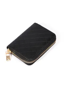 Black quilted leather card holder wallet with gold zipper and compact design for daily use.