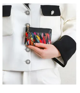 Stylish geometric print coin purse with secure zipper and convenient key ring for daily use.