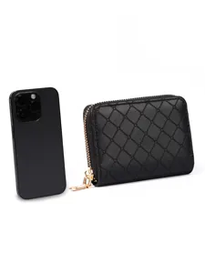 Detailed view of a black quilted zip wallet with accordion card slots and metal zipper pull.