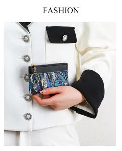 Close-up detail view of compact coin purse with blue geometric pattern and keyring.