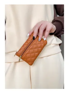 Brown PU quilted small coin purse detail view with dual zippers and compact design.