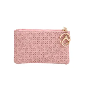 Pink woven mini coin purse for women with gold keychain, cute small wallet storage bag.