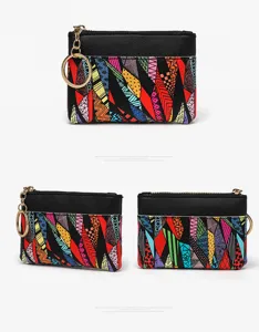 Colorful abstract geometric pattern coin purse with metal keychain and secure zipper closure.