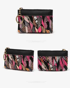 Detail view of stylish geometric coin purse with keyring and zipper closure for daily use.