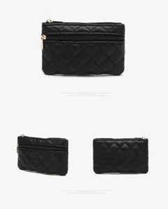 Detailed view of the black quilted PU leather mini coin purse with double gold zippers.