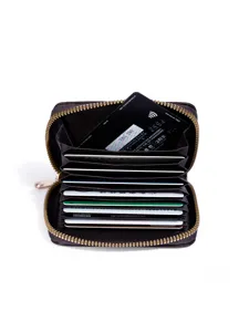 Brown leather accordion card holder with zipper closure and multiple slots for cards.