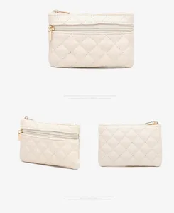 Beige quilted PU coin purse detail view showing dual gold zippers and soft leather texture.
