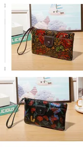 Womens vintage floral embossed leather clutch wallet with wrist strap and zipper closure style.