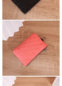 Detail view of small waterproof quilted coin pouch with bone pattern and metal keyring.