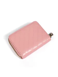Pink quilted zip card holder detail view, showing fine stitching and compact wallet design.