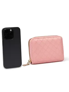 Pink quilted zip wallet detail view showing card slots and smooth zipper closure.