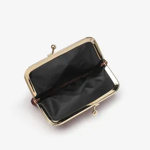 Classic kiss-lock coin purse with gold frame, compact change wallet for men and women daily use.
