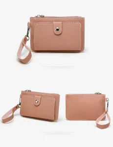 Detail view of pink PU leather coin purse wallet with wristlet strap and front snap pocket.
