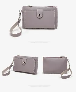 Grey PU leather coin purse detail showing zipper pocket, wristlet strap and snap button.