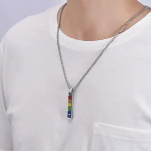 Close-up of men's titanium steel rainbow bar pendant necklace on a white t-shirt model