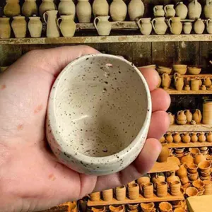 Handmade speckled ceramic pottery herb stripper bowl kitchen tool held in person's hand