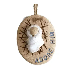 Handmade Baby Jesus resin ornament with Adore Him blue text and hemp rope hanger