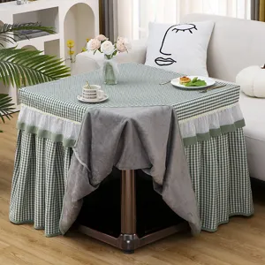 Green checkered square table cover with cozy grey fleece lining, perfect for heating tables.