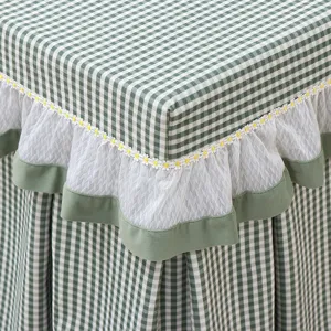 Green checkered table cover with white lace and daisy trim, square coffee table protector detail
