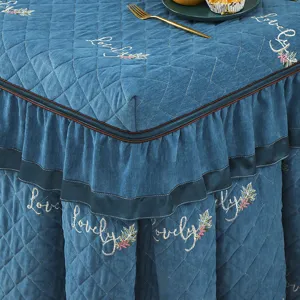 Thickened quilted table cover with ruffles and embroidery, close-up view of the fine texture.