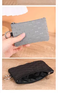 Close-up detail of waterproof coin purse featuring cute bone pattern, smooth zipper and key ring.