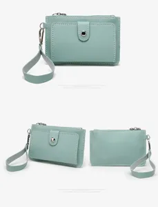 Detailed close-up view of light green PU leather coin purse featuring a handy wrist strap.