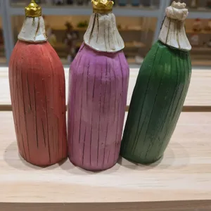 Detailed view of three resin wise men figurines in red purple and green for home decor