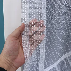 Close-up detail of white lace mesh curtain fabric showing fine texture and transparency.
