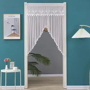 White lace door curtain with delicate embroidery and tassels for bedroom privacy and decor.