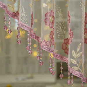 Close-up detail of French retro sheer curtain with pink floral embroidery and crystal beads.