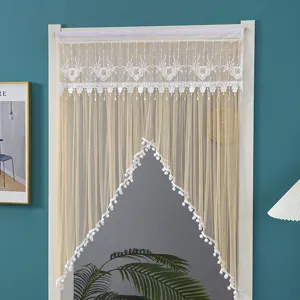 Mesh lace door curtain with intricate embroidery and pom-pom trim for bedroom privacy and decor.