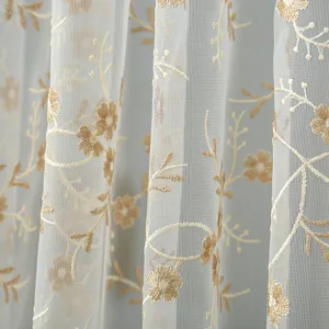 Close-up detail of Korean style sheer lace curtain fabric with gold embroidered floral pattern.