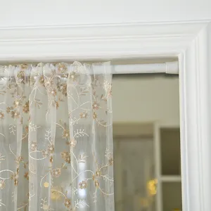 Detailed view of French vintage lace short curtain with gold embroidery, sheer door panel.