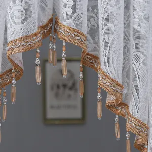 Close-up detail of white lace curtain with gold trim and beaded tassels, pastoral decor style.
