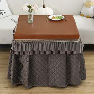 Detailed view of rectangle thermal table cover, brown waterproof top with thick quilted grey skirt.