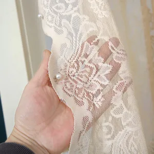 Exquisite French luxury lace curtain detail showing delicate floral pattern and soft texture.