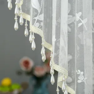 Korean lace curtain detail with delicate floral embroidery and elegant hanging pearl beads.