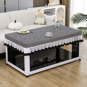 Detailed close-up view of a stylish black and white checkered tea table cover with lace ruffle.