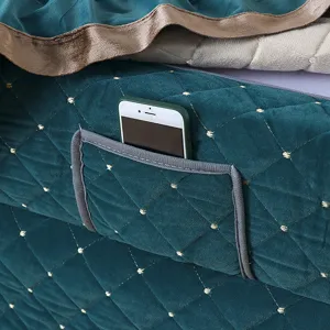 Close-up detail of dark green quilted heating table cover featuring a handy phone storage pocket.