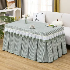 Green checkered table cover detail showing white lace ruffles and pleated skirt style.