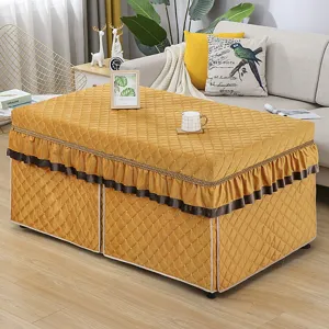 Quilted rectangular heating table cover with elegant brown ruffles, cozy winter home decor detail.