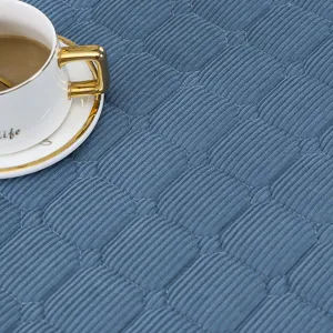 Blaue gesteppte quadratische Tischdecke Detailansicht, weiche Heiztisch Abdeckung Textur Nahaufnahme.