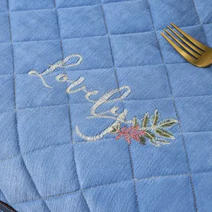 Thickened quilted blue tablecloth cover with elegant embroidery detail and soft fabric.