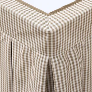 Brown and white gingham table cover detail showing pleated ruffle skirt and neat brown edge trim.