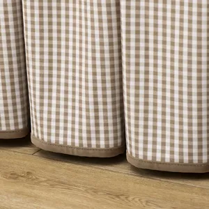 Detail shot of the brown and white gingham table cover hem, showing soft flannel binding.