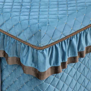 Thick blue quilted heating table cover detail, diamond stitching and brown ruffle for winter.