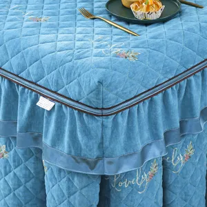Close-up of quilted blue heater table cover detail, soft velvet fabric texture and elegant ruffles.