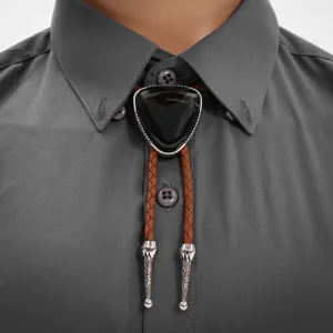 Close-up of retro Western bolo tie with black triangle stone and brown braided cord.