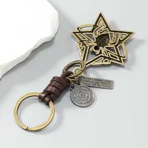 Detailed view of vintage metal spider star keychain with brown leather braid section.